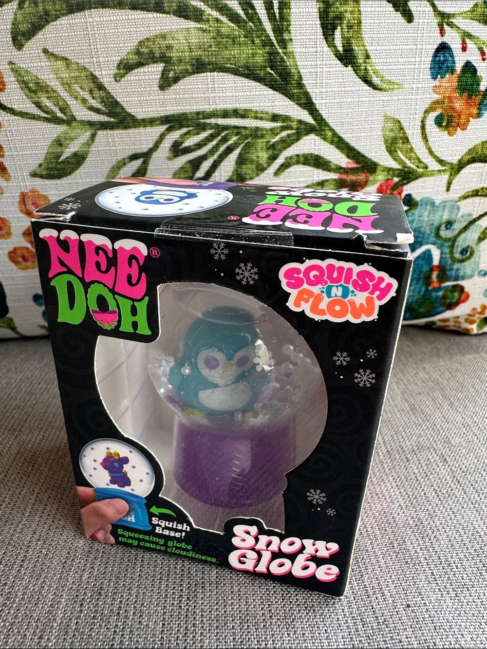 Collectible NeeDoh Squish N Flow Purple Snow Globe with Blue Penguin